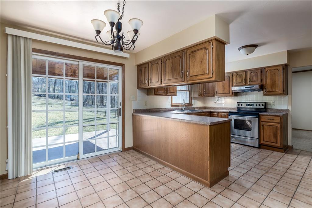 17 Cranberry Lane Cecil, PA 15321 - Photo 6 of 25 a kitchen with stainless steel appliances granite countertop a stove a sink and a microwave