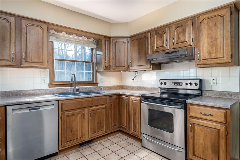 17 Cranberry Lane Cecil, PA 15321 - Photo 7 of 25 a kitchen with stainless steel appliances granite countertop a sink stove and cabinets