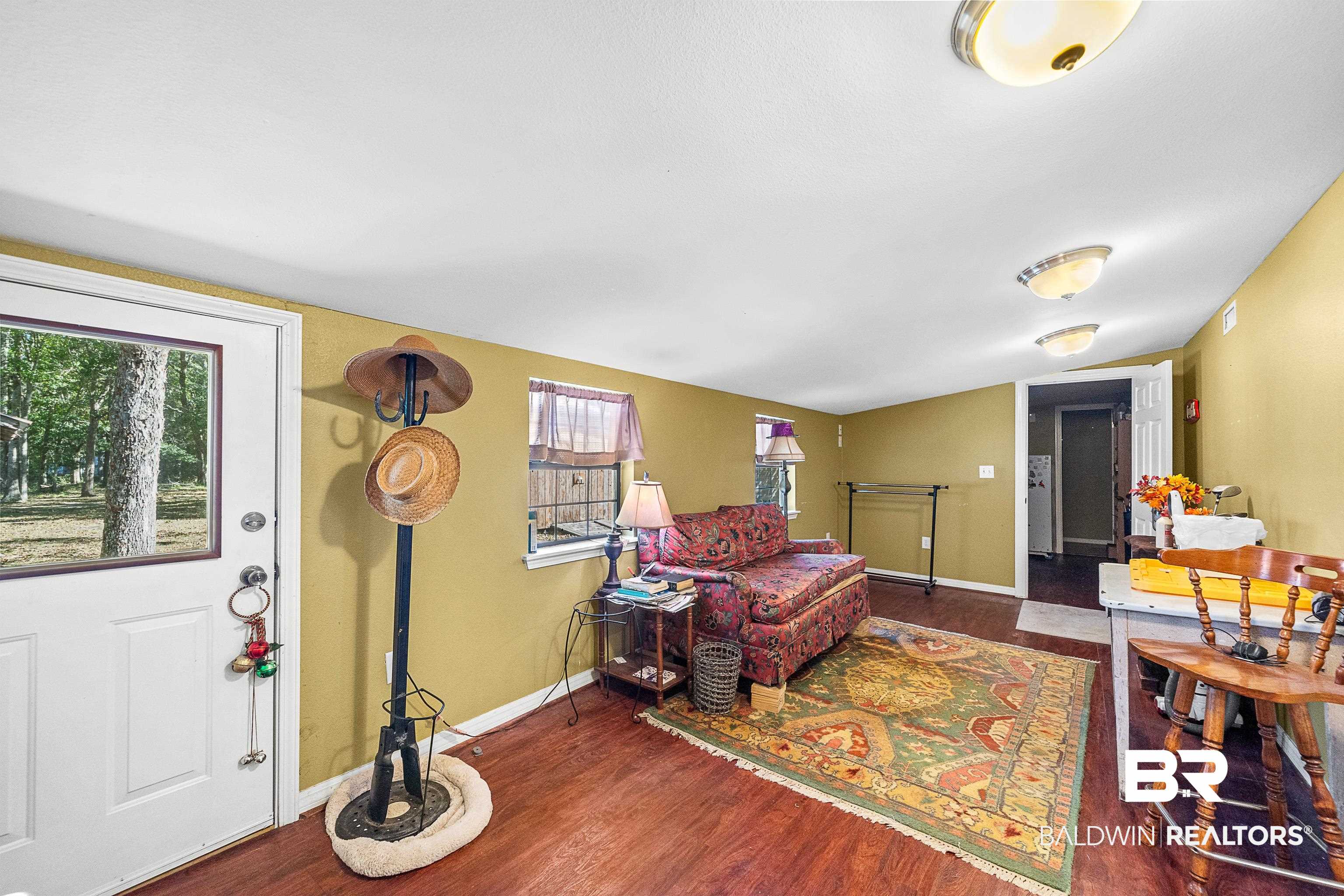 11528 Whitehouse Fork Road Bay Minette, AL 36507 - Photo 21 of 37 Living area featuring dark wood-type flooring and baseboards