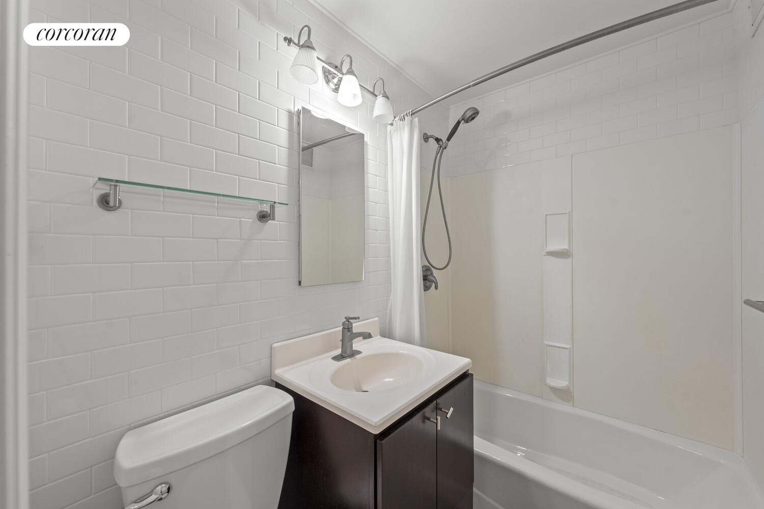 75 Henry Street, Unit 18J Brooklyn, NY 11201 - Photo 10 of 13 a bathroom with a sink toilet and shower