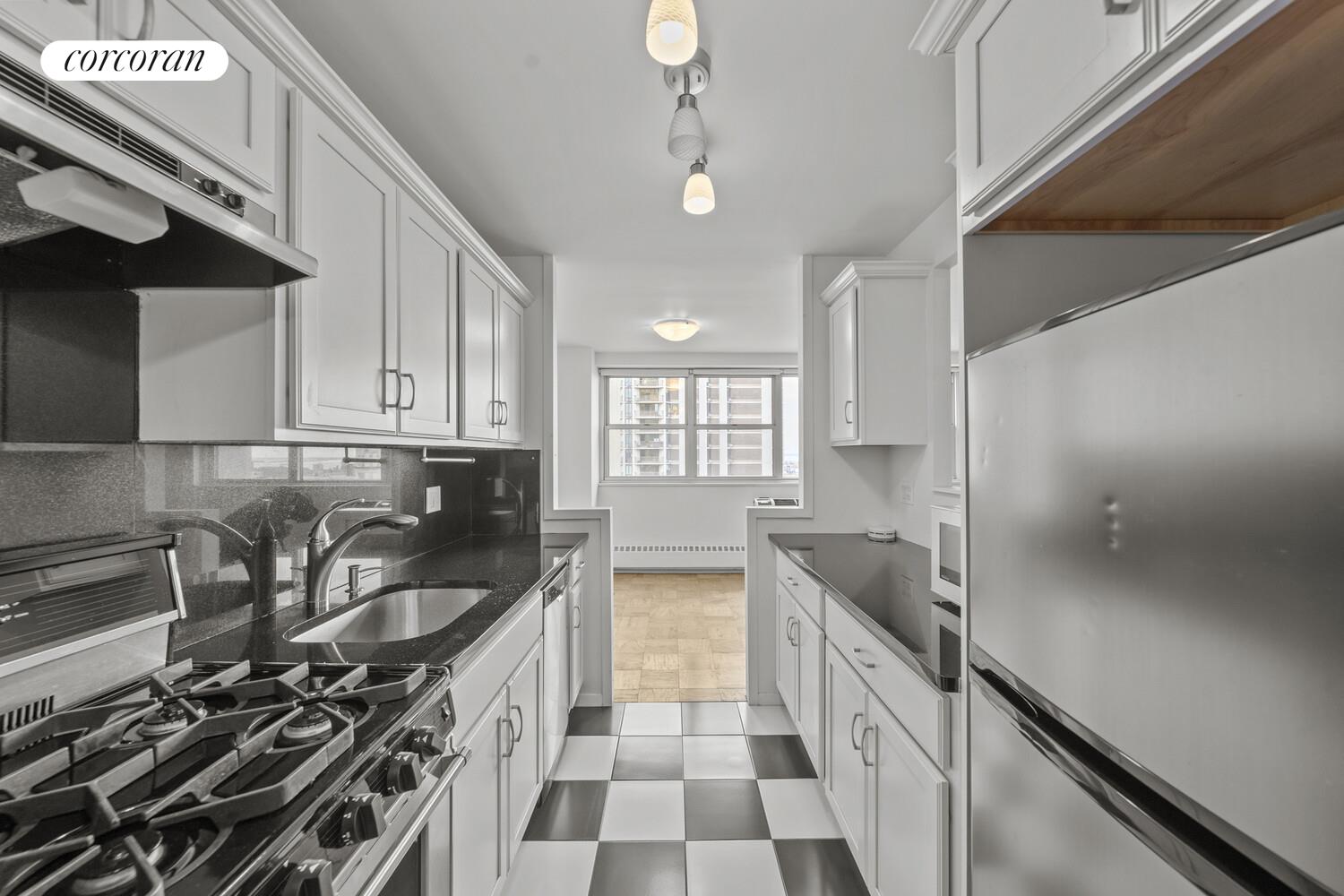 75 Henry Street, Unit 18J Brooklyn, NY 11201 - Photo 9 of 13 a kitchen with stainless steel appliances a sink stove and cabinets