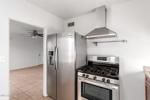 a kitchen with stainless steel appliances a stove and a refrigerator