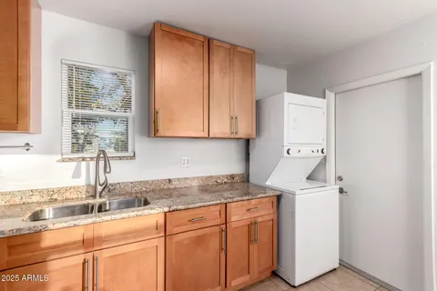 a kitchen with stainless steel appliances granite countertop a sink and a white cabinets