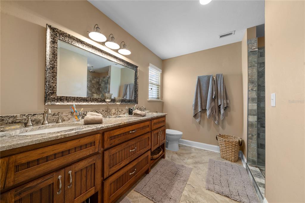 4639 Southwest Wilson Springs Road Fort White, FL 32038 - Photo 17 of 76 a spacious bathroom with a double vanity sink and a mirror
