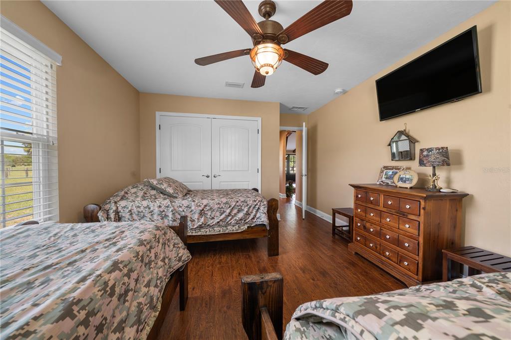 4639 Southwest Wilson Springs Road Fort White, FL 32038 - Photo 22 of 76 a bedroom with a bed and a flat screen tv
