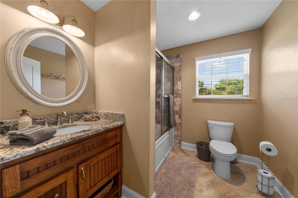 4639 Southwest Wilson Springs Road Fort White, FL 32038 - Photo 23 of 76 a bathroom with a toilet a sink and a mirror