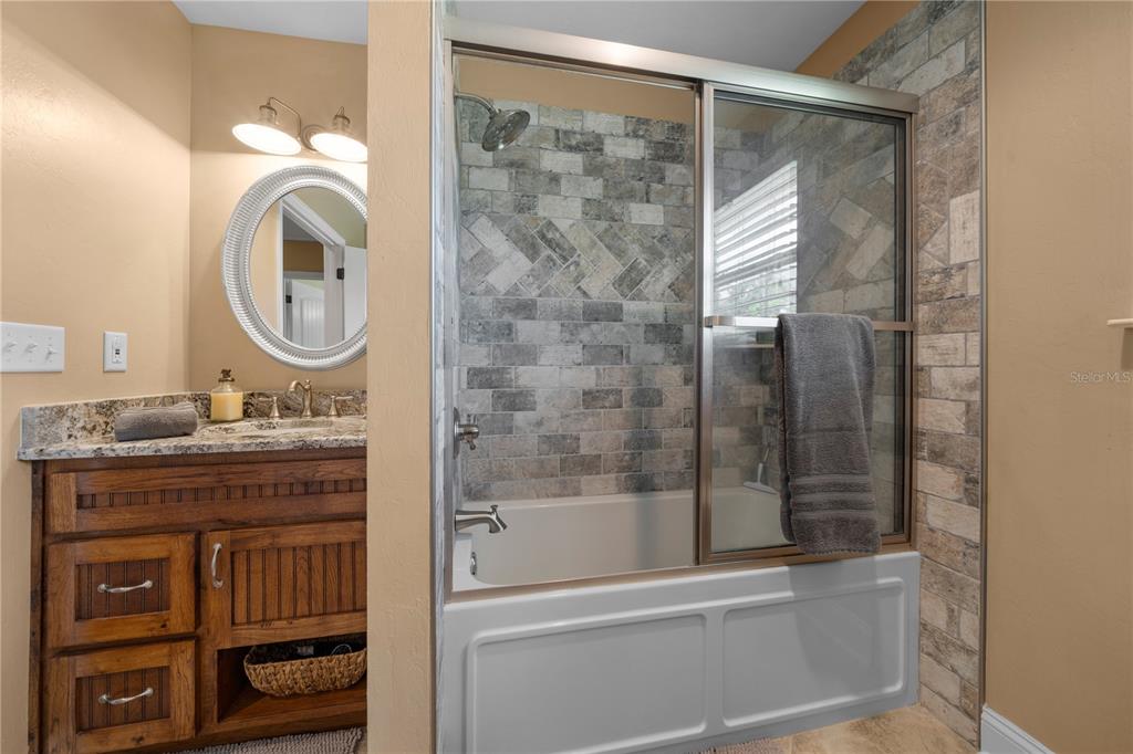 4639 Southwest Wilson Springs Road Fort White, FL 32038 - Photo 24 of 76 a bathroom with a granite countertop sink a toilet and a mirror