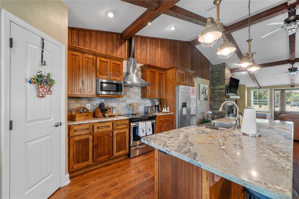 4639 Southwest Wilson Springs Road Fort White, FL 32038 - Photo 3 of 76 a kitchen with stainless steel appliances granite countertop a sink refrigerator and cabinets