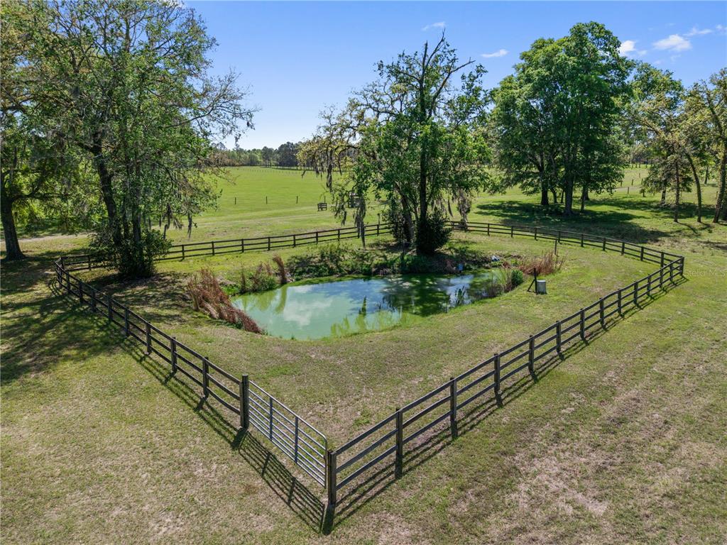 4639 Southwest Wilson Springs Road Fort White, FL 32038 - Photo 38 of 76 a view of a swimming pool with an outdoor seating and a lake view