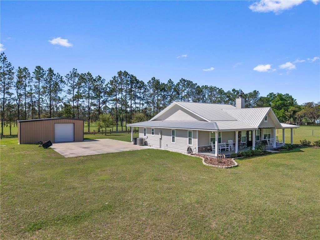 4639 Southwest Wilson Springs Road Fort White, FL 32038 - Photo 45 of 76 a view of a house with pool and chairs