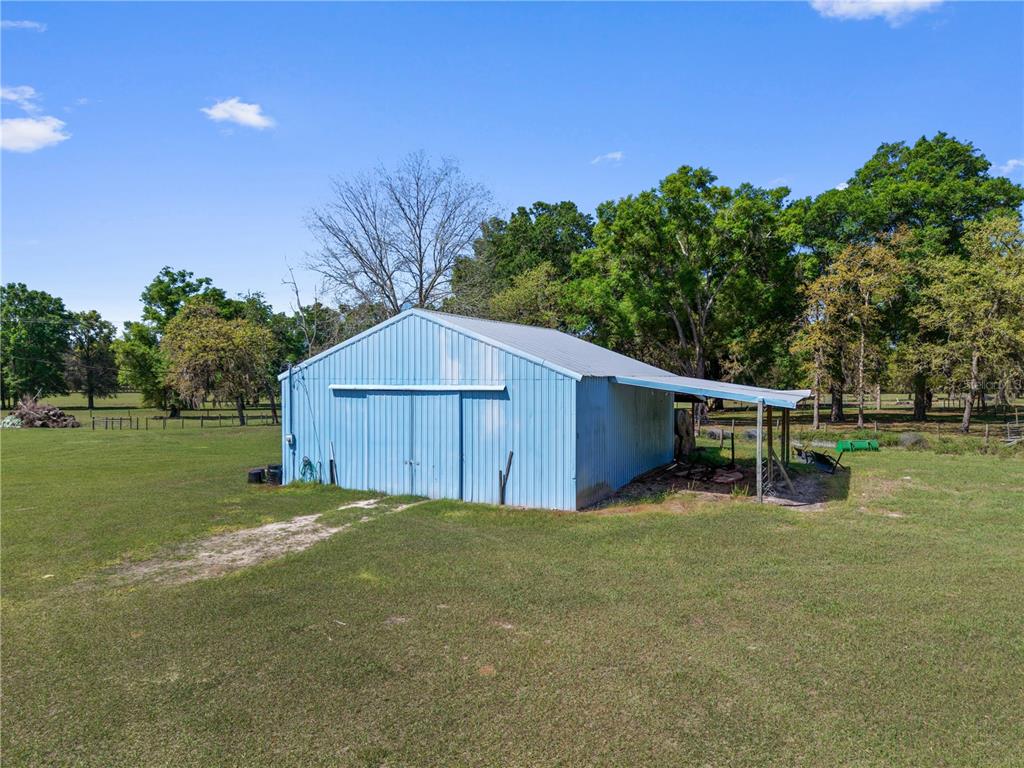 4639 Southwest Wilson Springs Road Fort White, FL 32038 - Photo 46 of 76 a backyard of a house with table and chairs