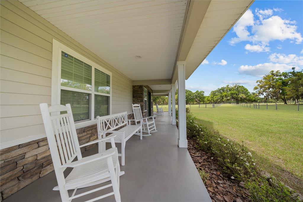 4639 Southwest Wilson Springs Road Fort White, FL 32038 - Photo 6 of 76 a view of an chairs and table in the patio