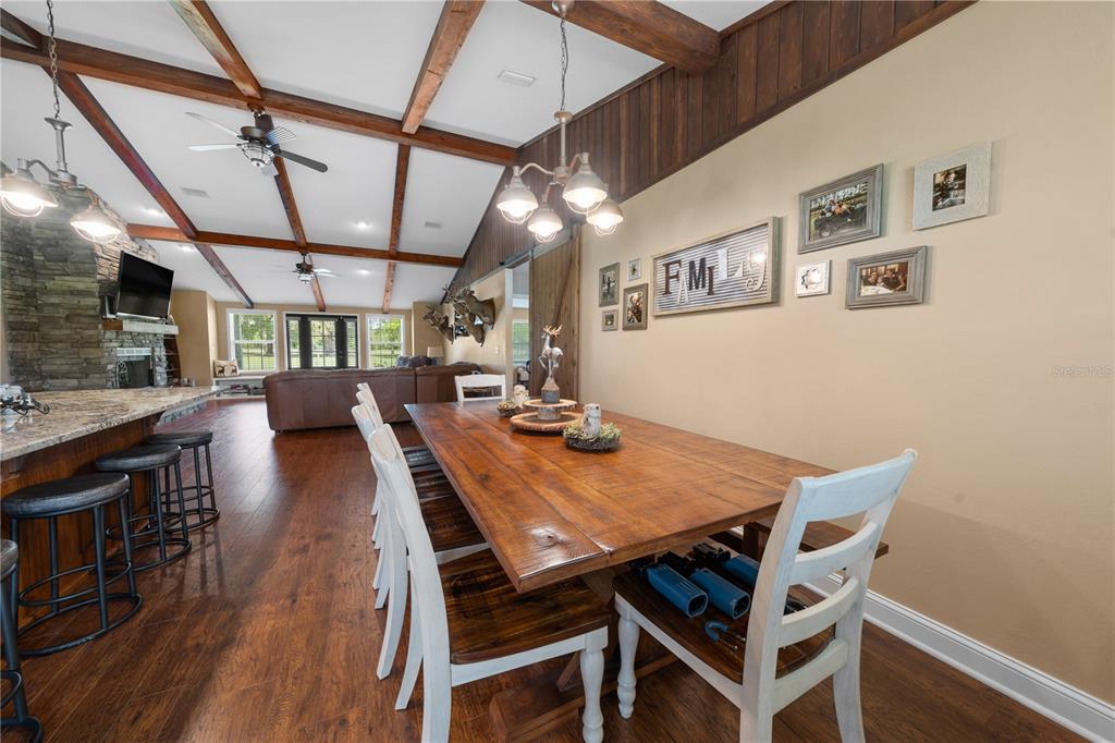 4639 Southwest Wilson Springs Road Fort White, FL 32038 - Photo 10 of 76 a view of a dining room with furniture and wooden floor