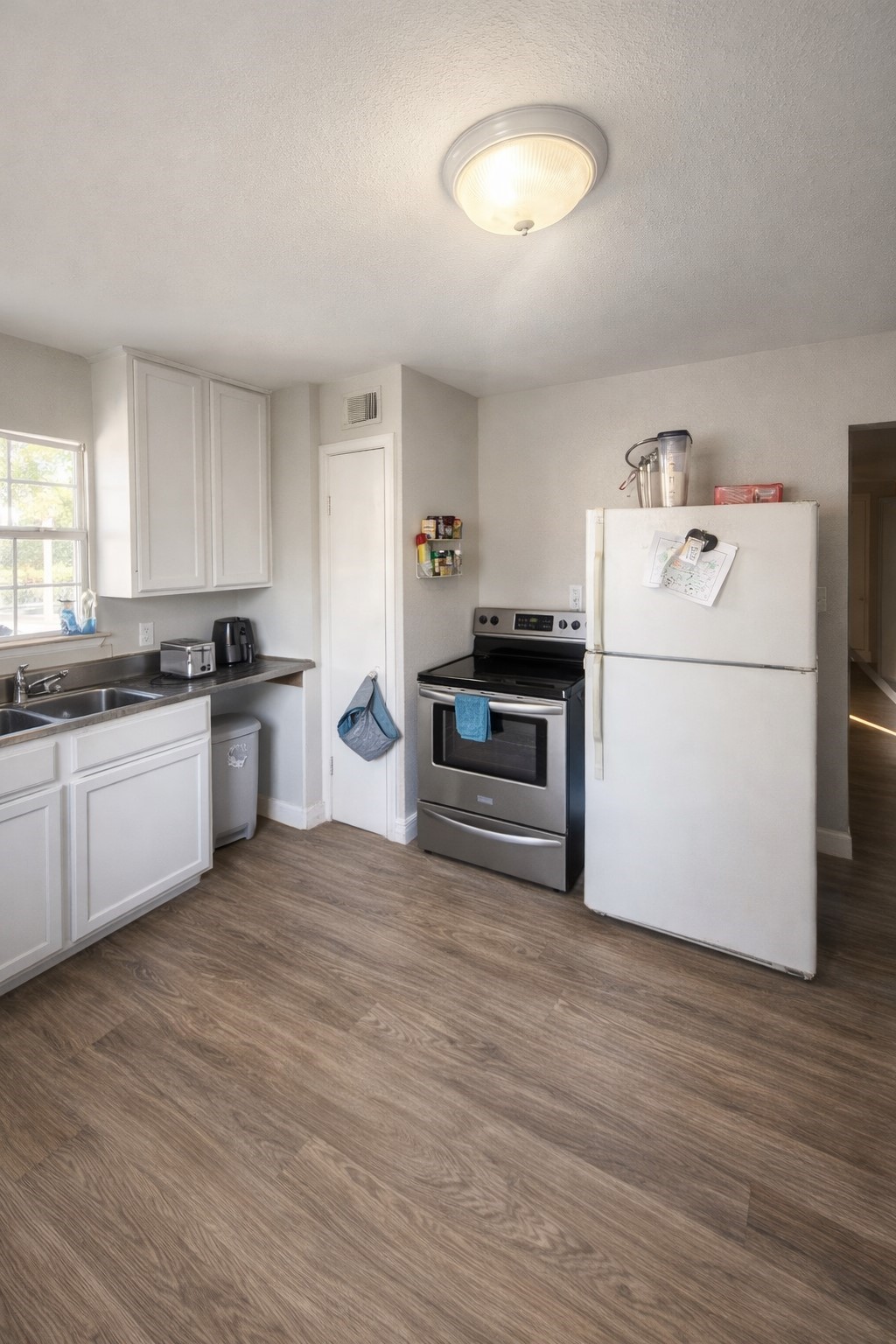 817 Church Street Crosby, TX 77532 - Photo 2 of 18 a kitchen with a sink cabinets and wooden floor
