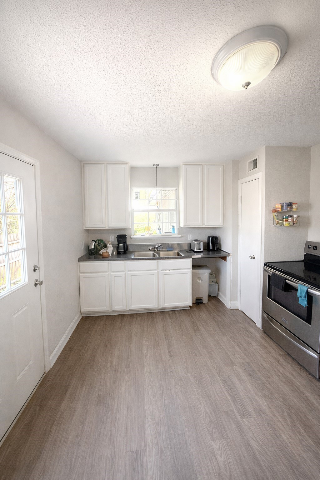 817 Church Street Crosby, TX 77532 - Photo 2 of 8 a kitchen with stainless steel appliances a refrigerator sink and cabinets