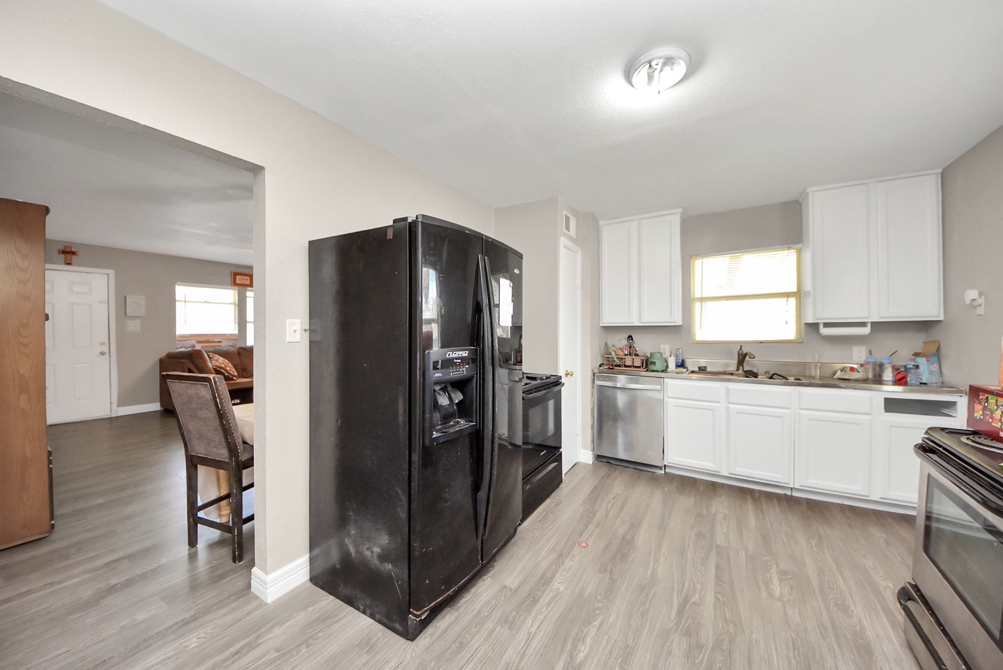 817 Church Street Crosby, TX 77532 - Photo 6 of 18 a kitchen with a refrigerator and white cabinets