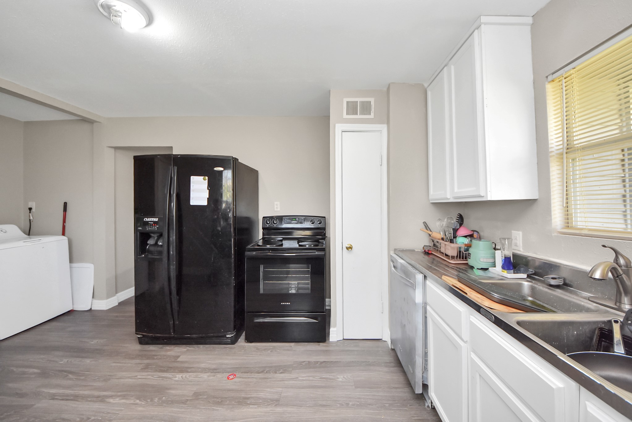 817 Church Street Crosby, TX 77532 - Photo 7 of 18 a kitchen with a refrigerator and a sink