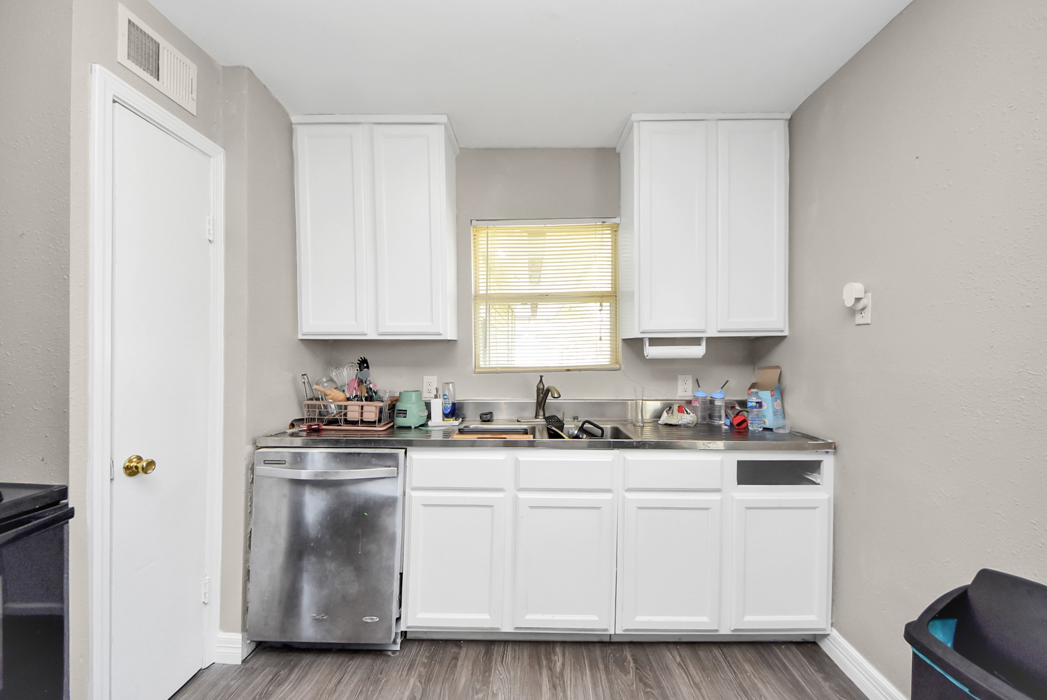 817 Church Street Crosby, TX 77532 - Photo 8 of 18 a kitchen with white cabinets and white appliances