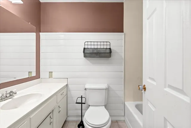 a bathroom with a sink a toilet and mirror