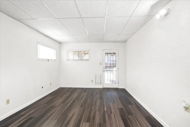 a view of a room with wooden floor and window