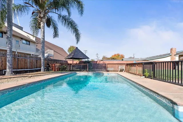 a view of a house with swimming pool and sitting area