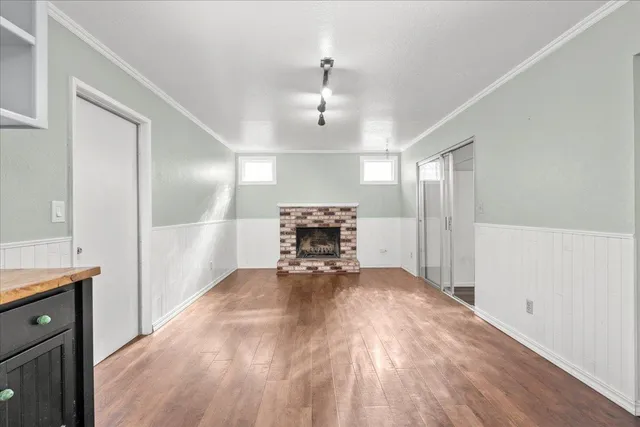 a view of empty room with wooden floor