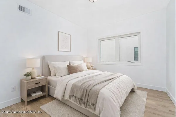 a bedroom with a bed and a window