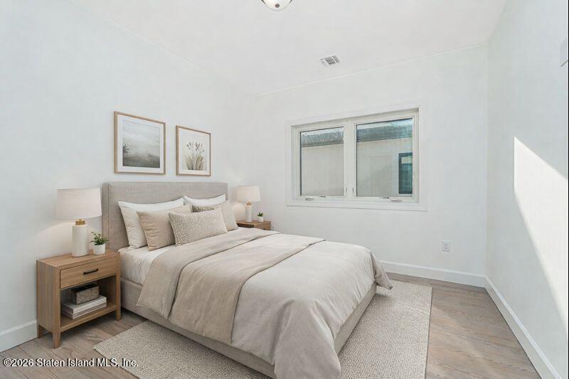 909 Rathbun Avenue Staten Island, NY 10309 - Photo 16 of 35 a bedroom with a bed and a window