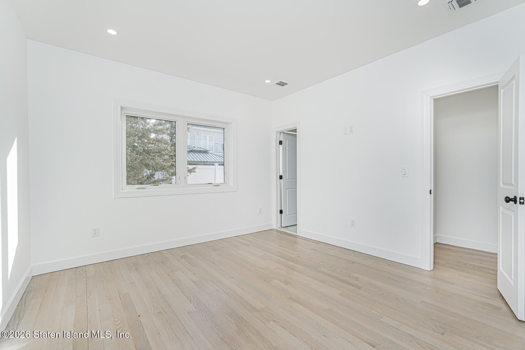 909 Rathbun Avenue Staten Island, NY 10309 - Photo 29 of 35 an empty room with wooden floor and window