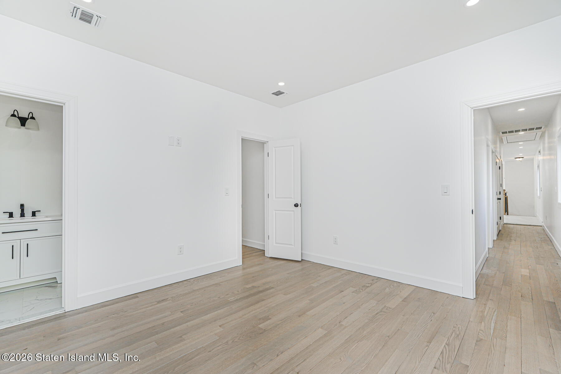 909 Rathbun Avenue Staten Island, NY 10309 - Photo 30 of 35 an empty room with wooden floor
