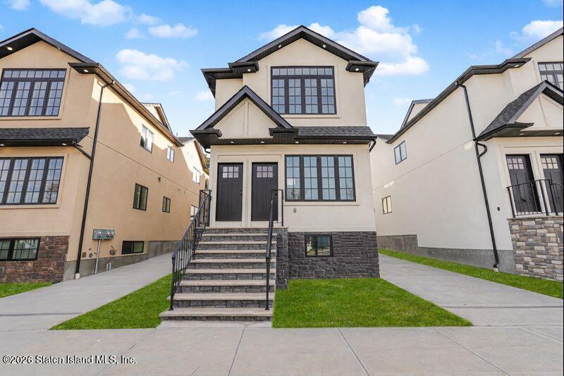 909 Rathbun Avenue Staten Island, NY 10309 - Photo 3 of 35 a front view of a house with a yard