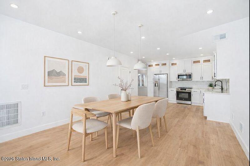 909 Rathbun Avenue Staten Island, NY 10309 - Photo 9 of 35 a view of a dining room with furniture and wooden floor