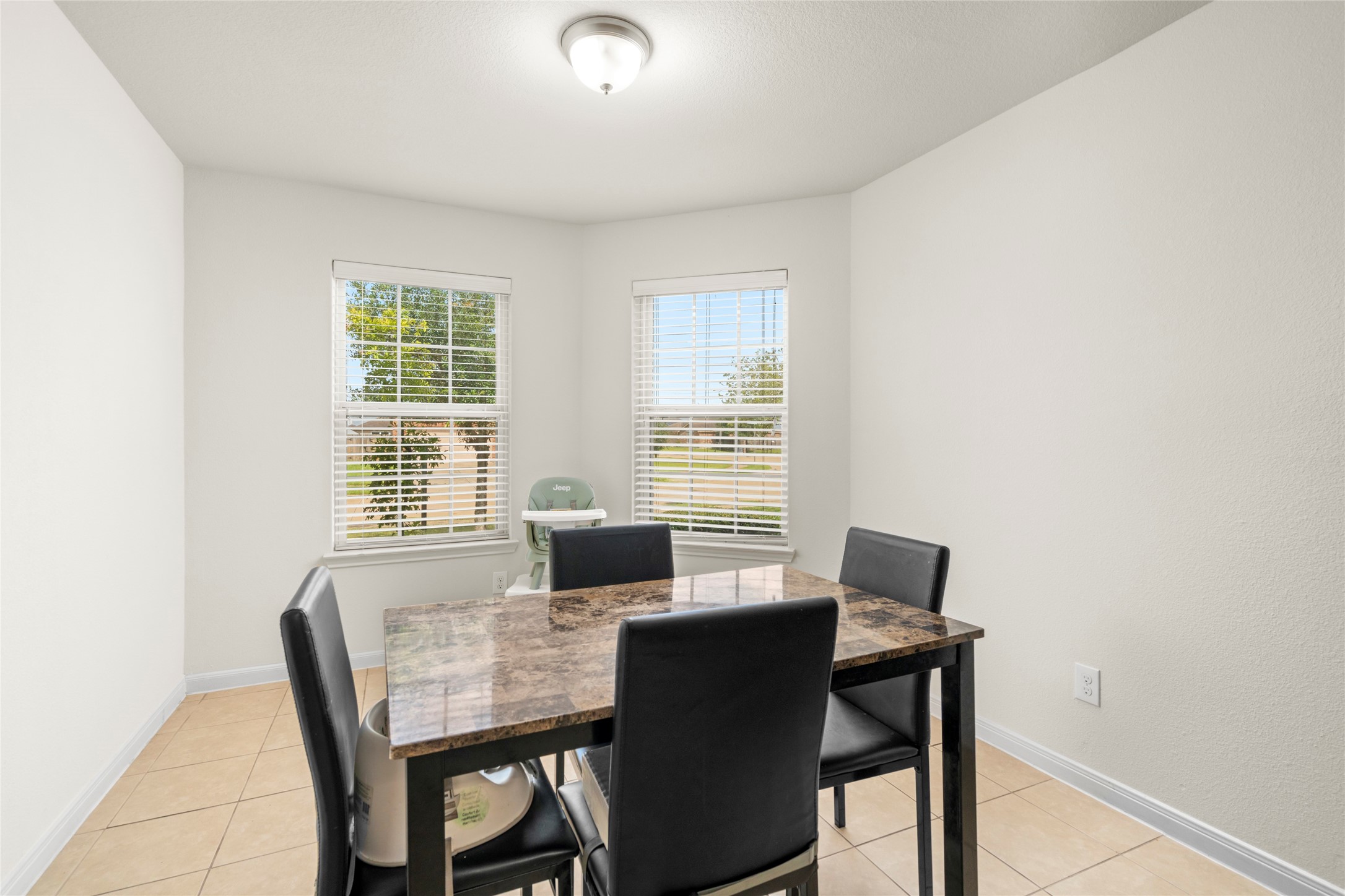 9719 Montana Sapphire Lane Rosharon, TX 77583 - Photo 19 of 40 Bright dining area with windows and an open feel connected to the kitchen.