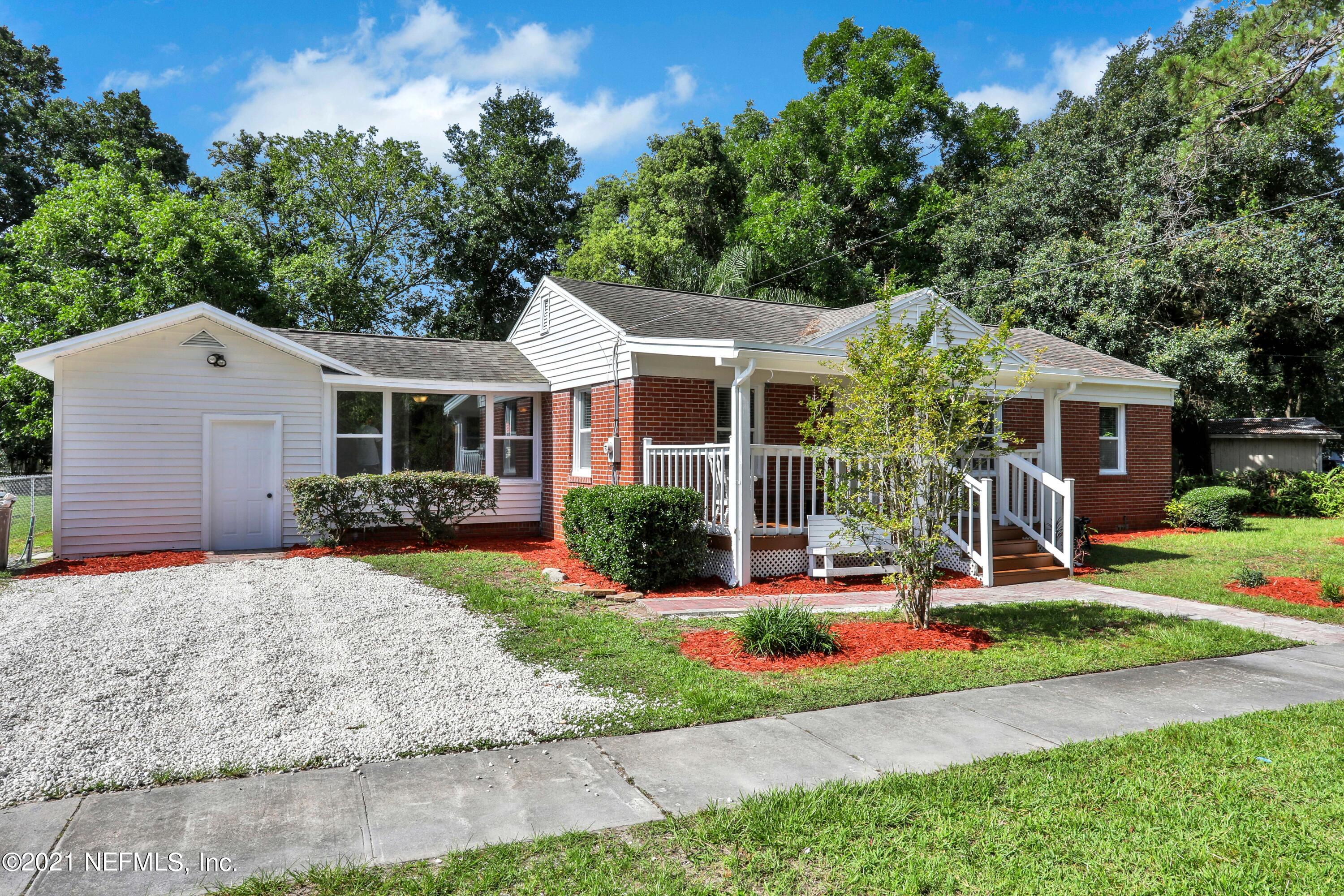 a front view of a house with a yard and porch