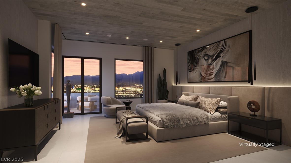 505 Overlook Rim Drive Henderson, NV 89012 - Photo 11 of 22 City lights twinkle beyond the balcony, offering breathtaking views from this serene primary bedroom.