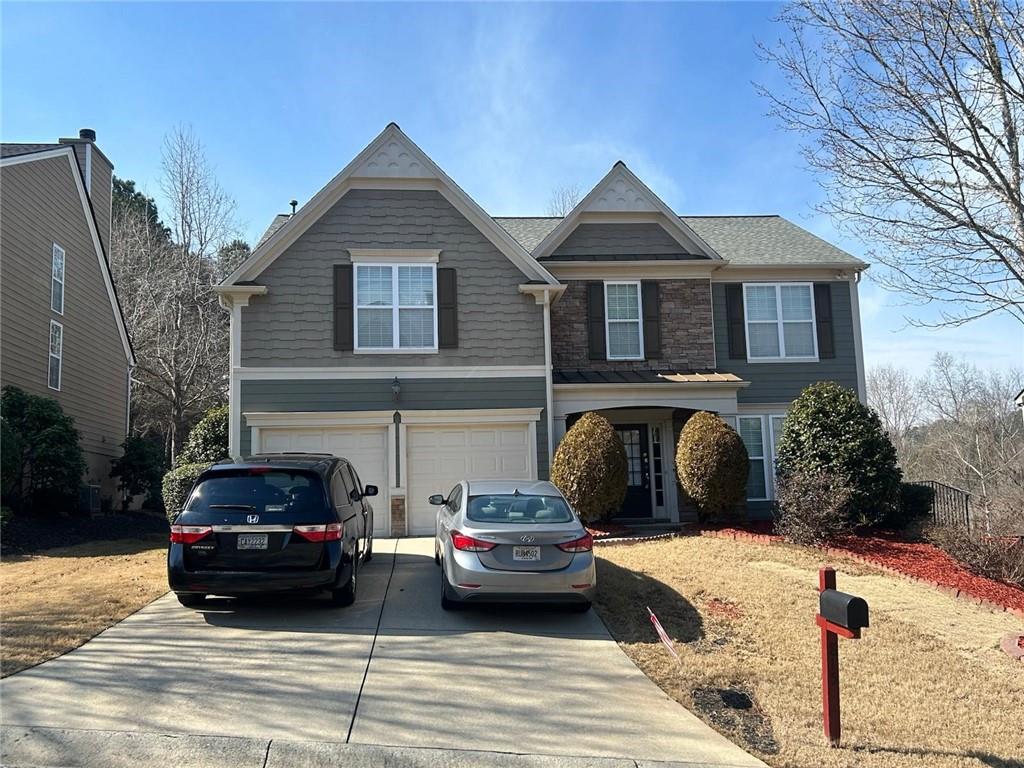 815 Earlham Drive Suwanee, GA 30024 - Photo 1 of 30 a front view of a house with cars parked