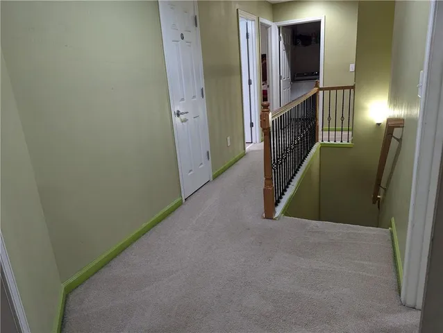 a view of an entryway door and hallway