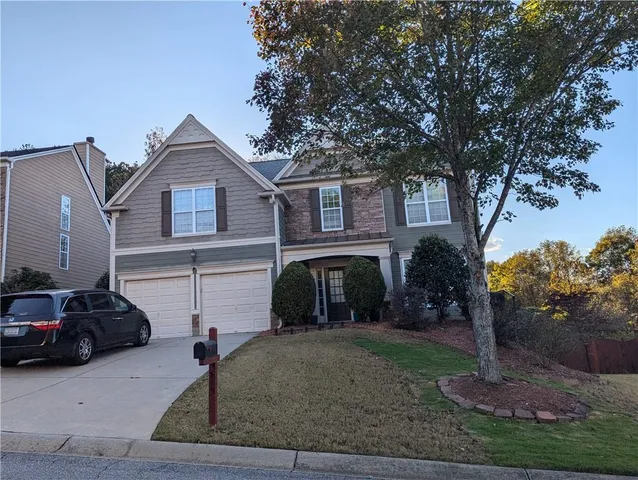a front view of a house with garden