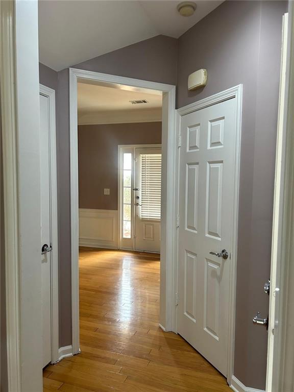 815 Earlham Drive Suwanee, GA 30024 - Photo 21 of 30 a view of a hallway with wooden floor and a bathroom
