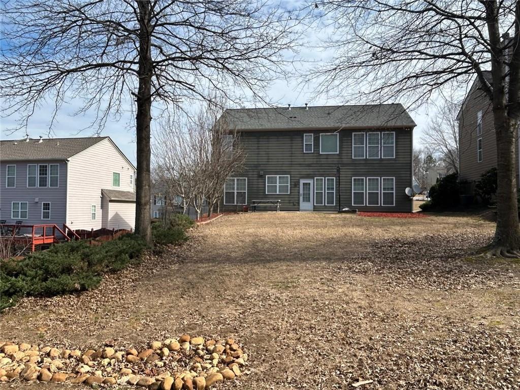 815 Earlham Drive Suwanee, GA 30024 - Photo 28 of 30 a front view of a house with a garden