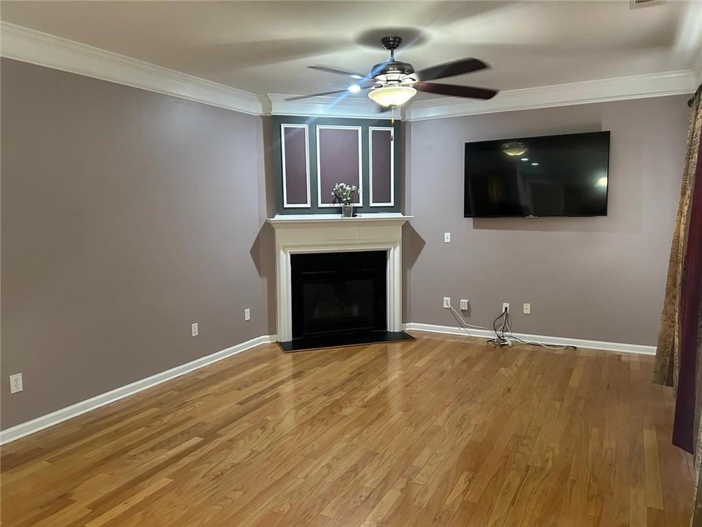 815 Earlham Drive Suwanee, GA 30024 - Photo 6 of 30 a view of an empty room with a fireplace and a flat screen tv