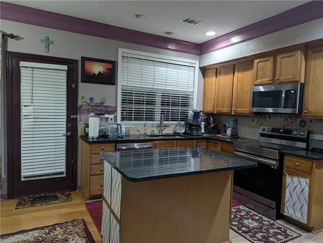 a kitchen with sink a window and cabinets