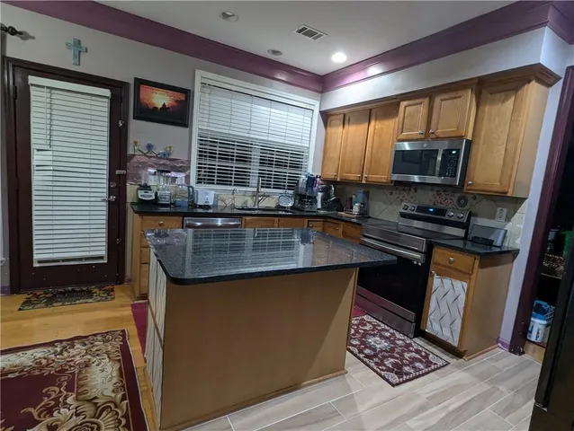 a kitchen with sink and refrigerator