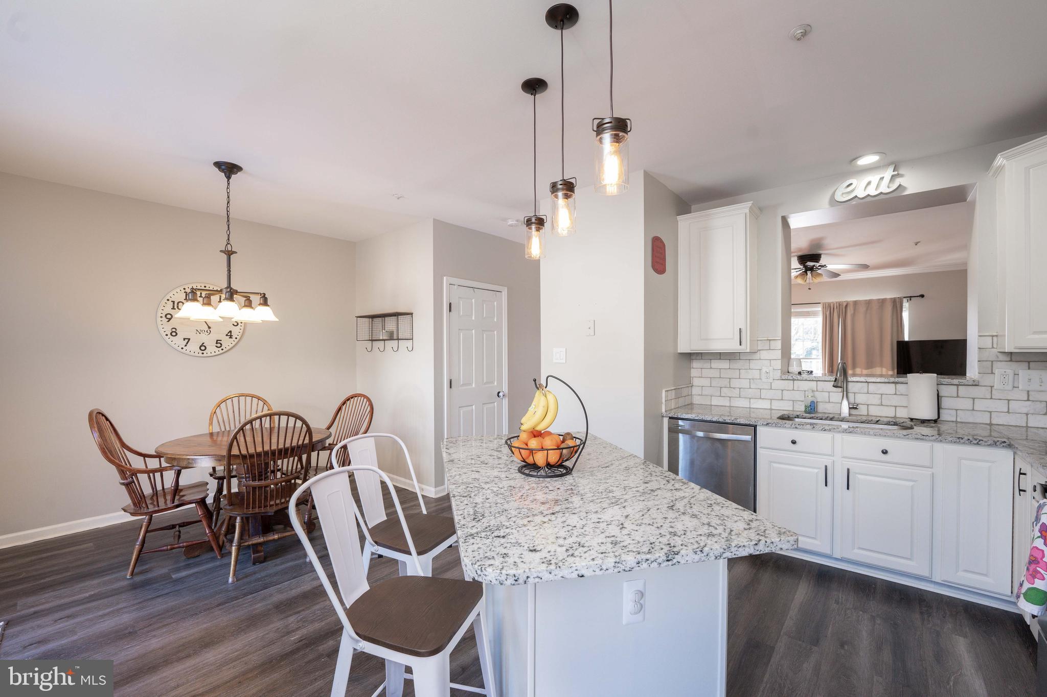 2170 Sewanee Drive Forest Hill, MD 21050 - Photo 12 of 34 a kitchen with stainless steel appliances granite countertop a dining table chairs and sink