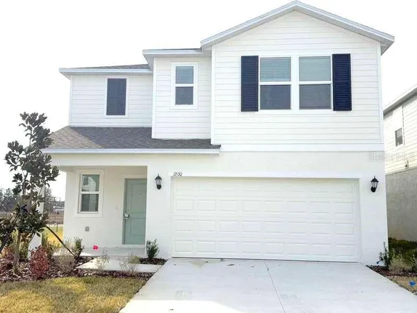 a front view of a house with a yard garage and outdoor seating