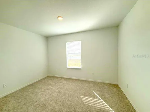 a view of a livingroom with furniture and a window
