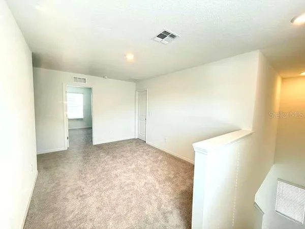 an empty room with windows and closet