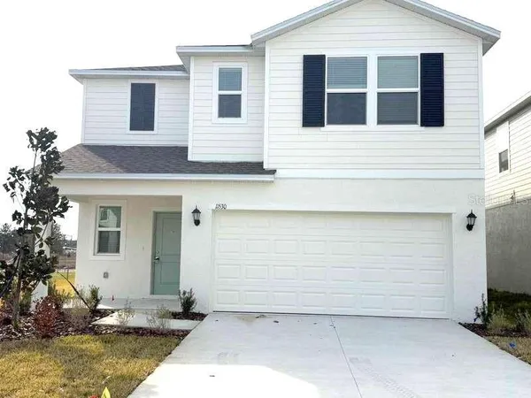a view of a house with a yard and sitting space