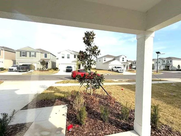 a large white kitchen with stainless steel appliances granite countertop a refrigerator and a stove top oven
