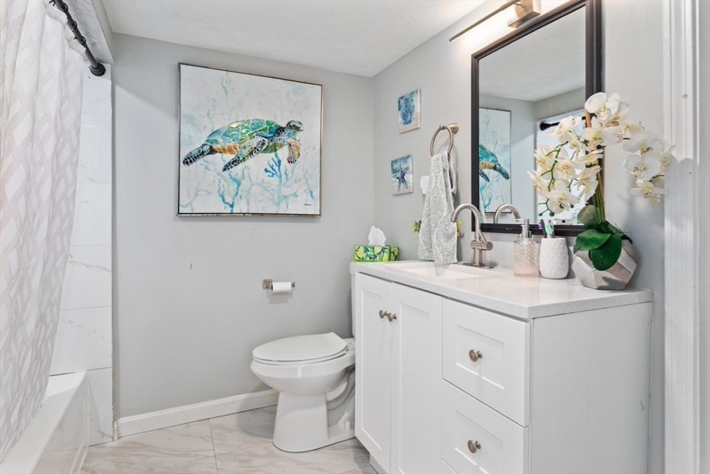14 Bay Road Revere, MA 02151 - Photo 17 of 38 a bathroom with a sink a toilet and a mirror